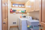 Laundry room with washer and dryer plus detergents for guest use.